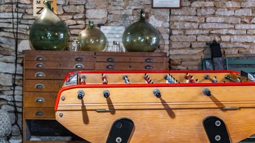 a wooden dresser with two large green vases on it at L'Ombelle in Selongey