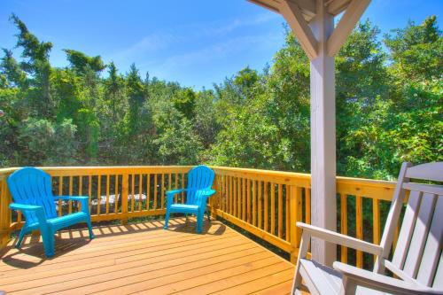 two blue chairs sitting on a wooden deck at 2012 - Grateful Duck in Duck