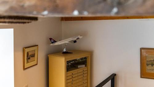 a toy airplane is sitting on top of a dresser at L'Ombelle in Selongey