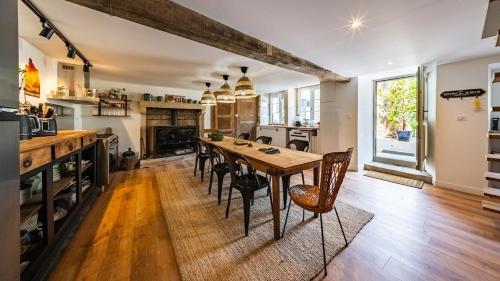 a kitchen with a wooden table and chairs at L'Ombelle in Selongey