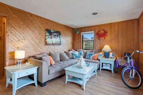 a living room with a couch and a bike at 7145 - Geri's Place #6 Flip Flop in Wanchese