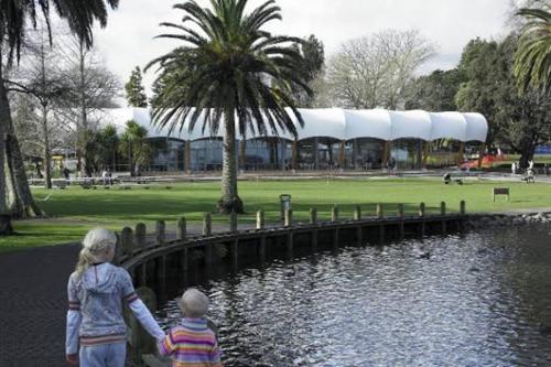 two children standing next to a pond in a park at Lakeside Retreat with Swim Spa in Hamilton