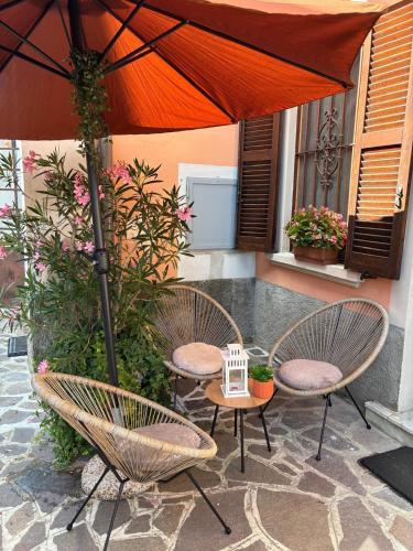 two chairs and a table with an umbrella on a patio at Casetta Serena in Capriate San Gervasio