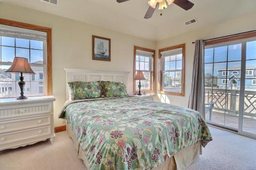 a bedroom with a bed and windows and a ceiling fan at 4124 - Sound Side Out in Kitty Hawk