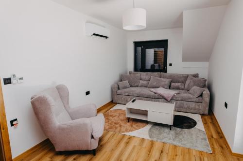 a living room with a couch and a chair at Novak Home in Štrigova