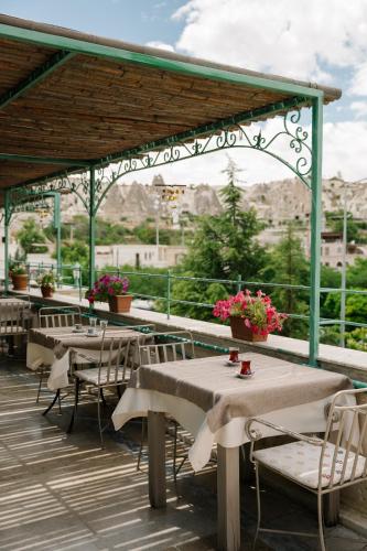 a row of tables and chairs on a deck at Heybe Hotel & Spa in Goreme