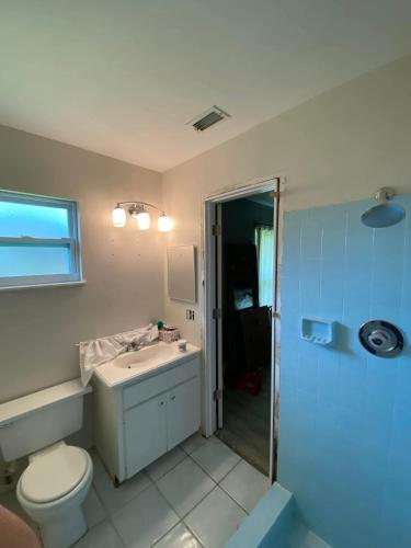 a bathroom with a toilet and a sink and a shower at Pink Maraboi Resort in Kisumu