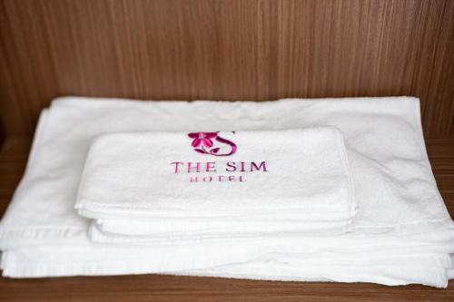 a pile of towels sitting on top of a table at The Sim Hotel Vung Tau in Vung Tau