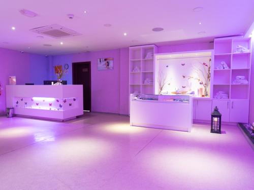 a room with purple walls and a room with shelves at Sheki Palace Hotel in Sheki