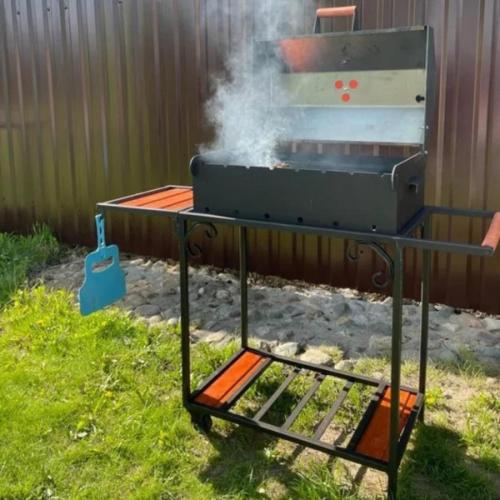 a grill with smoke coming out of it in a yard at Villa Sunshine ,apartment with 4 bedrooms ,whole apartment, апартаменты целиком in Dilijan