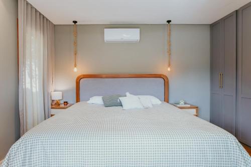 ein Schlafzimmer mit einem Bett mit einer grünen und weißen Decke in der Unterkunft Luxo e Aconchego na Natureza - DM in Domingos Martins