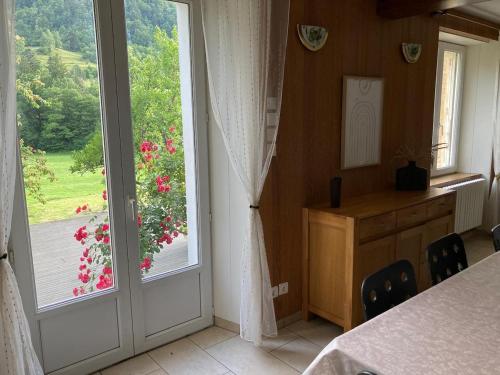 a room with a window with a view of a garden at Le Gîte d'Orion in La Bresse