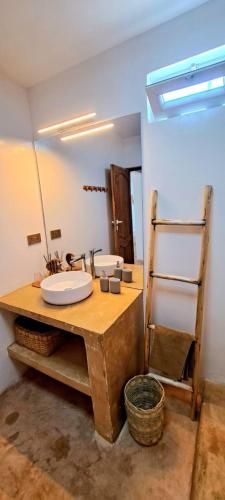a bathroom with two sinks and a mirror at Boho Boutique Hotel - Beachfront , Adults Only , Private Pool in Kiwengwa