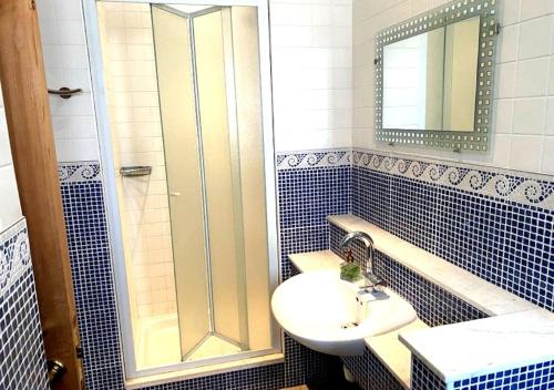 a bathroom with a sink and a shower at Olive Tree House in Anoyira