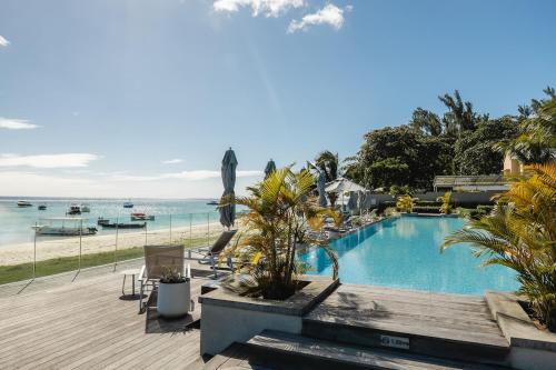 a swimming pool with a view of the beach at OBiches Penthouse C1 Beachfront Complex in Trou aux Biches
