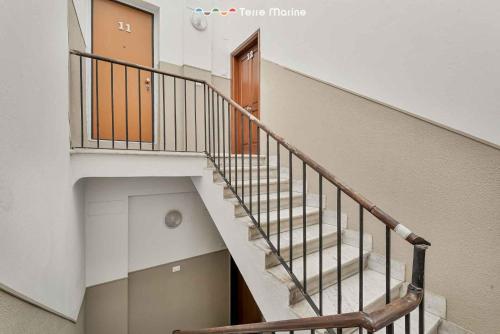 a staircase in a building with a stair case at Maestrale 11, Terre Marine in La Spezia