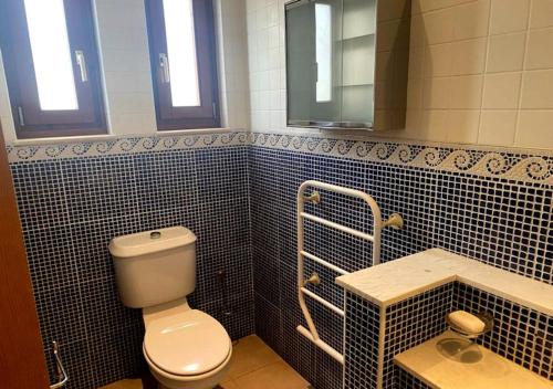 a bathroom with a toilet and a sink at Olive Tree House in Anoyira