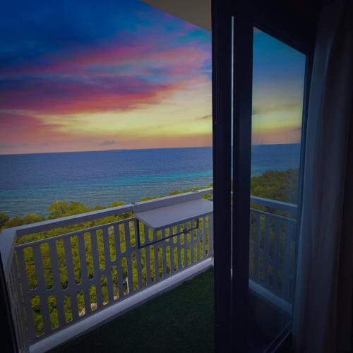 a view of the ocean from a balcony at Aqua Horizon Beachside Condo I Signature Art Suites in Dauis