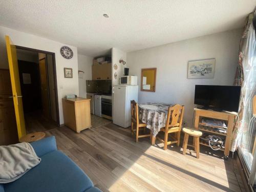 un salon avec une cuisine et une table et des chaises dans l'établissement Résidence Equinoxe - studio face aux pistes en centre de station MAE-5291, à Vénosc