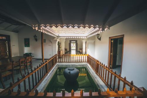 an indoor pool in a building with a vase in it at Sisikirana Villa (Luxury Villa in Galle) in Unawatuna