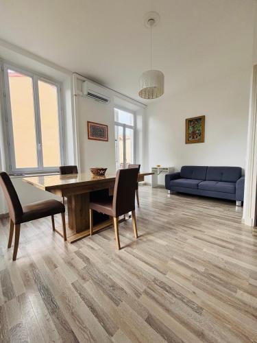 un salon avec une table et un canapé bleu dans l'établissement T3 City Center MENTON, à Menton