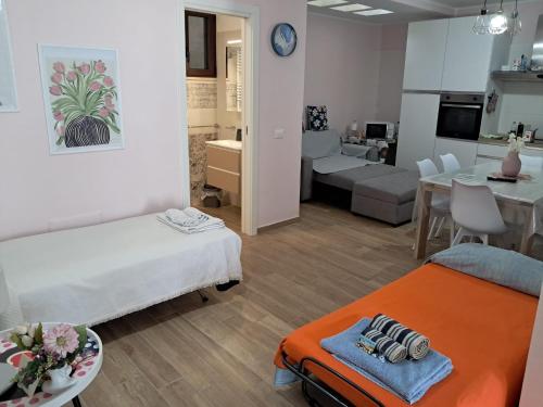 a room with two beds and a living room at Villa MARGHERITA in Pratola Peligna