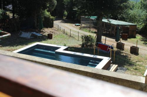 a swimming pool in a yard with a playground at Villa Lilia by Let in Siena