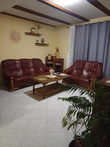 a living room with two leather couches and a coffee table at Petra in Ražanac