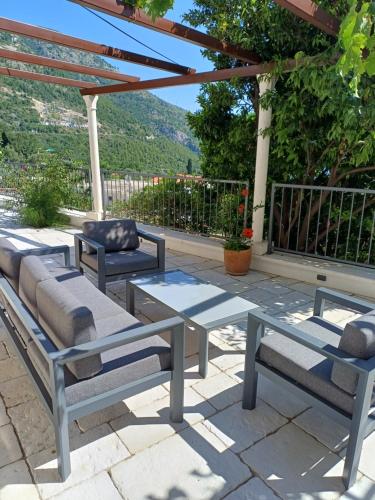 a patio with two benches and a table and a pergola at Ardura shimmering on the sea in Mlini