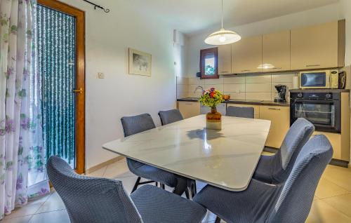a dining room with a table and chairs in a kitchen at Holiday Home Kavran With Fireplace 03 in Kavran