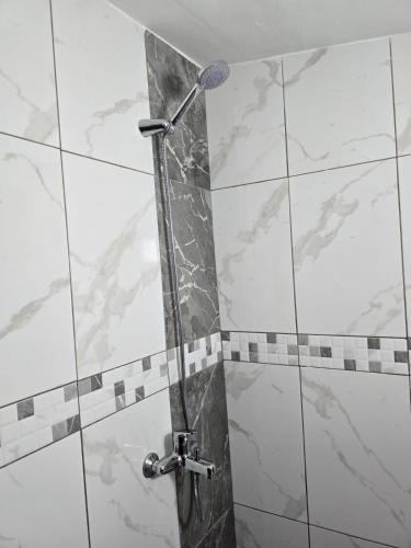a shower in a bathroom with a glass door at TRiAD in Vlorë