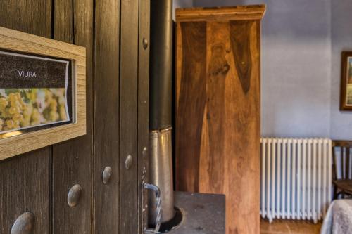a wooden door with a picture on the wall at Can Pei in Oix