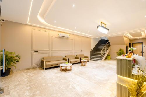 a lobby with a staircase and a waiting room at Hotel Zest Near IGI Airport in New Delhi