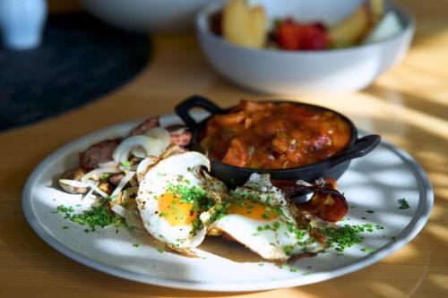 a plate of food with eggs on a table at Hotel Bosak in Szczecin