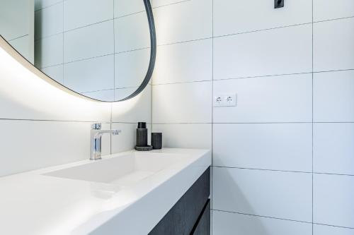 a bathroom with a sink and a mirror at Villa Jazmyn 15 Blue Bay Beach with Private pool in Sint Michiel