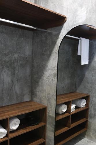 a bathroom with wooden shelves and a mirror at Apartamentos 31 in Progreso
