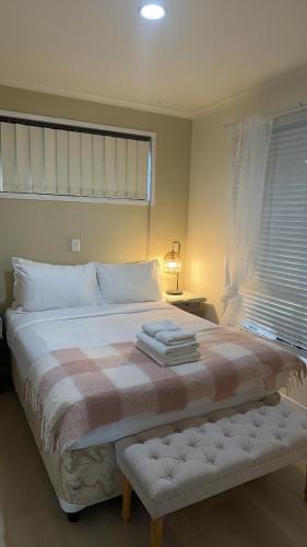 a bedroom with a large bed with a blanket at Comfortable 1 Bedroom Granny Flat with Parking Alexandra Hills in Ormiston