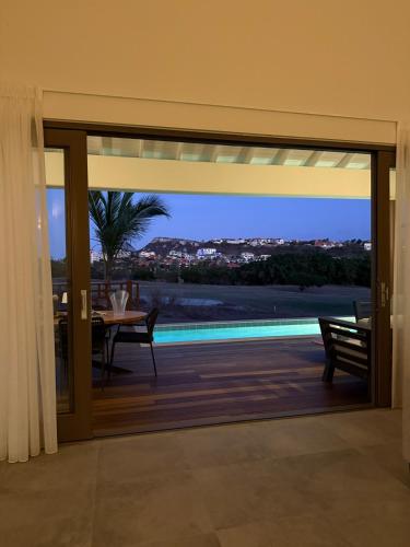 a glass door of a house with a view of a pool at Villa Jazmyn 15 Blue Bay Beach with Private pool in Sint Michiel