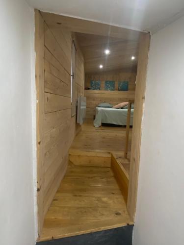 a hallway leading to a bedroom in a tiny house at Chambres d’hôtes La Voûte in Volonne