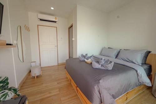 a bedroom with a large bed with blue pillows at Le soleil koh Larn in Ko Larn