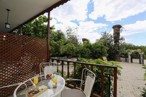a patio with a table and chairs on a balcony at Villa Christina in Tolo