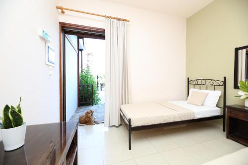 a bedroom with a bed and a window at Villa Christina in Tolo