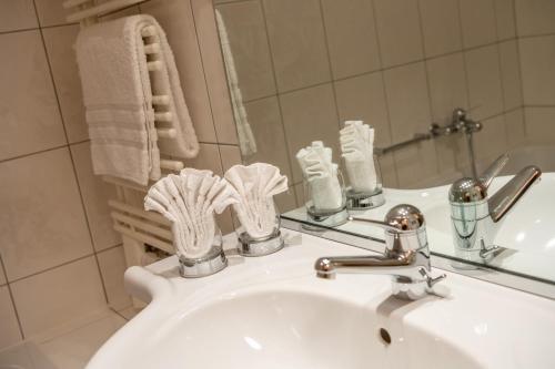 a bathroom with a white sink and a mirror at Dolce Vita in Saas-Fee