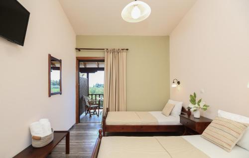 a bedroom with a bed and a couch in a room at Villa Christina in Tolo