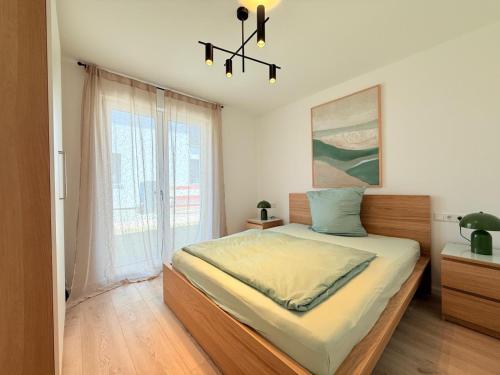 a bedroom with a bed and a large window at Suite Happiness in Uhldingen-Mühlhofen