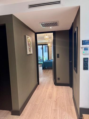 an empty room with a hallway with wood floors at La Casa d'Indie in Perpignan