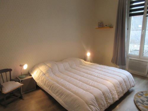 a bed in a bedroom with two lights on at Brav ehanou Morgat in Crozon