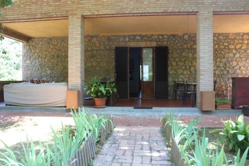 a front porch of a house with a patio at Villa Lilia by Let in Siena