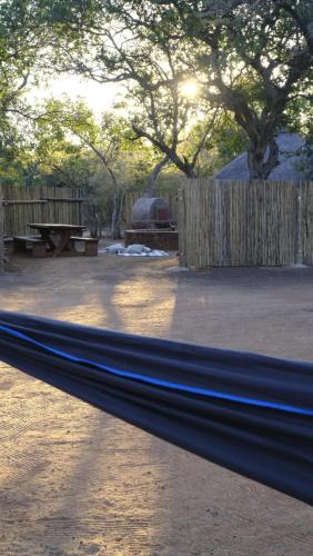 a park with a bench and a wooden fence at Mologa River Lodge in Rust de Winter