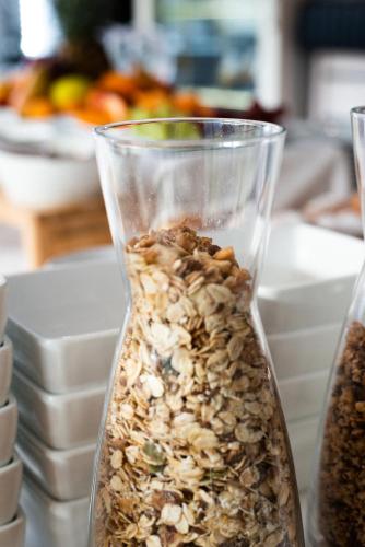 a glass vase filled with nuts on a table at Hotel De Nac in Nago-Torbole